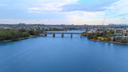 Obraz premium Aerial Drone View of Wentworth Point and Rhodes a suburb in western Sydney newly built residential high rise apartments area on Parramatta River Sydney NSW Australia