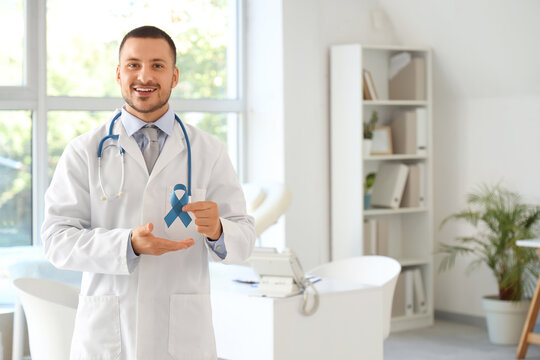 Male urologist with blue ribbon in clinic. Prostate cancer awareness concept