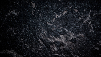 Dark textured marble stone surface with natural patterns