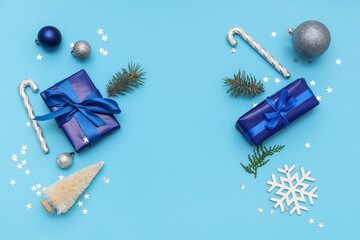 Obraz premium Festive composition with gift boxes and Christmas decorations on blue background