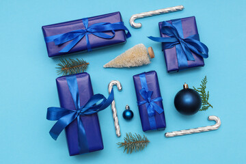 Festive composition with gift boxes and Christmas decorations on blue background