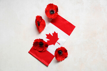 Poppy flowers and flag of Canada on light grunge background. Remembrance Day