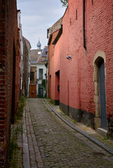 A Narrow Alley in Ghent Belgium. A picturesque cobblestone alley between historic buildings. Ghent, Belgium.
