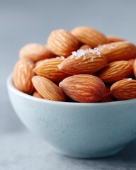 Macro Close Up Of Almonds In A Light Blue Bowl With Coarse Salt Sprinkled On Top Cinematic HDR Lighting Detailed Texture