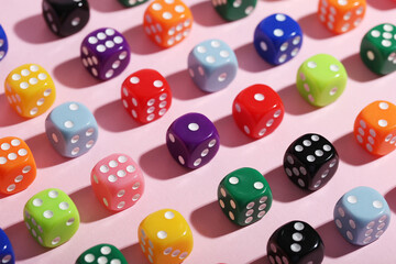 Colorful game dices on pink background