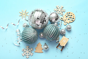 Composition with disco balls and Christmas decor on blue background, closeup