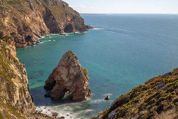 Lourical beach rock formation with turquoise ocean water