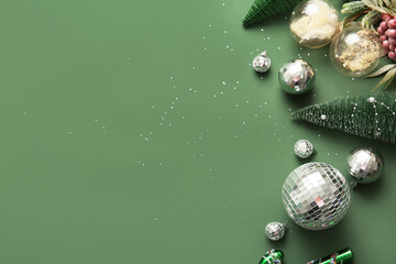 Composition with disco balls and Christmas decor on green background