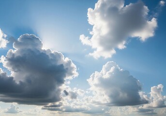 A high-resolution photograph of a bright blue sky filled with soft, fluffy cumulus clouds. The clouds appear voluminous and scattered across the horizon, illuminated by natural sunlight. Captured from