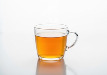 A clear glass mug filled with amber colored liquid isolated on white background
