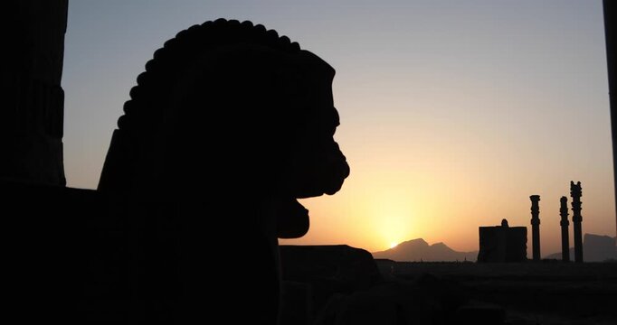 Silhouetted winged bull capital and ancient columns of Persepolis at sunset as the sun drops behind the Zagros. A quiet frame of heritage, empire and endurance across Iran&rsquo;s desert horizon.