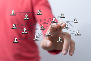 Symbolic image of a hand interacting with a network of human icons, representing connectivity, communication, and teamwork. Ideal for business,