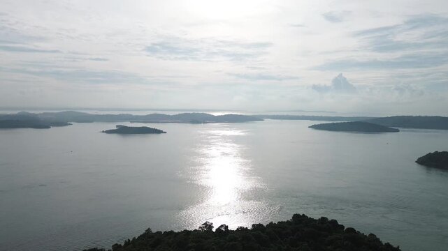 Expansive Aerial View of a Tropical Archipelago with Brilliant Sun Reflections on Water