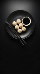 Black Plate with Dumplings and Soy Sauce on White Background