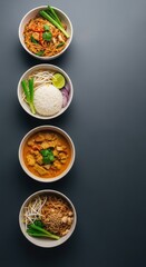 Assorted Asian Soups and Noodle Dishes in White Bowls on Dark Surface