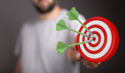 Image of a dartboard with three darts hitting the bullseye, symbolising achievement, success, and...
