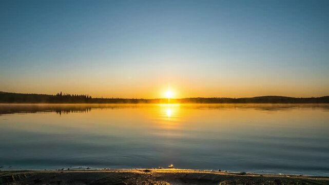 A hyperlapse shot from a camera on a rail captures the sun rising exactly at the horizon, creating a 50/50 split of sky and reflecting water.