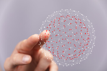 Hand reaching towards a digital sphere representing global connection, technology, and futuristic...