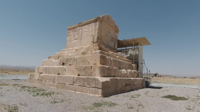 Frontal view of the Tomb of Cyrus the Great in Pasargadae, Iran&mdash;stepped limestone platform beneath a cloudless sky. Historic Achaemenid monument with a serene desert atmosphere.