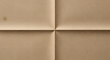 Aged brown paper sheet folded into four equal quadrants creating a central cross crease.
