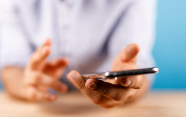 Close up of a man's hands holding a smartphone. Communication and connection concept. Using social media on mobile phone.