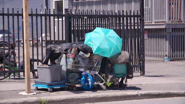 Rack focus to homeless encampment in a big urban city