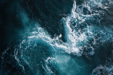 Aerial View of Deep Blue Ocean Water with White Foaming Waves and Shimmering Sunlight Reflections Creates a Dynamic Seascape