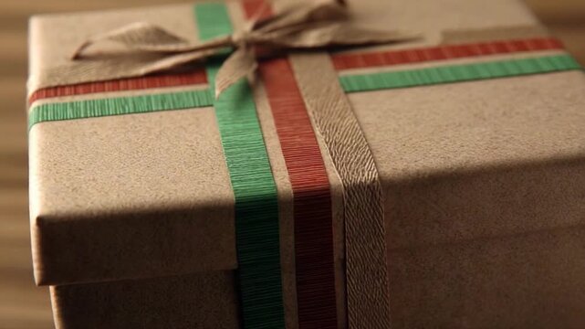 Wrapped Gift Box with Ribbon: A close-up of a neatly packaged gift box tied with a decorative ribbon, exuding anticipation, festivity, and warmth.