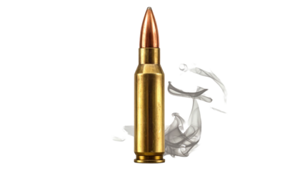 Single gold cartridge upright on a black backdrop with blurred white elements behind