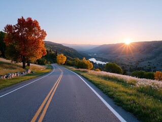 Fototapeta premium Scenic Rural Road Meanders Through a Sun-Drenched Valley During Golden Hour with Autumn Foliage and Distant Lake