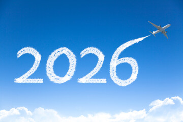 Happy New year 2026 concept travel on the background below cloudscape. Drawing by passenger airplane vapor contrail in sky.