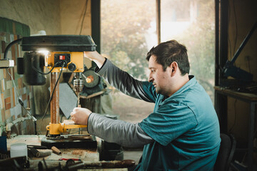 Latino man working in his workshop. Knife maker.
