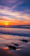 Vibrant ocean sunset with waves crashing against rocky beach coast