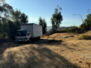old white truck abandoned in the desert - empty, no people, nobody - dry mountain landscape with shrubs and trees - Escondido, California, USA