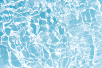 Blue water with ripples on the surface. Defocus blurred transparent blue colored clear calm water surface texture with splashes and bubbles. Water waves with shining pattern texture background.