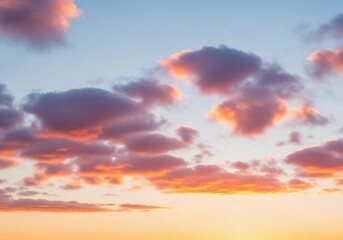 A peaceful evening sky with scattered cumulus clouds glowing in warm orange, pink, and light blue hues. The sun sets below the horizon, casting soft light rays upward. Captured in full HD from a groun