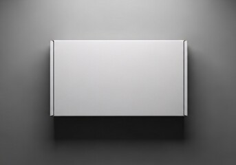 Top down view of a blank white rectangular product packaging box mockup on a dark grey background