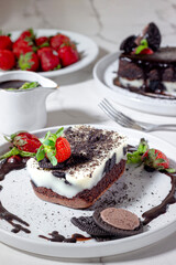 Chocolate Lava Cake with Oreo, Mint Leaf, and Strawberry Topping on White Plate