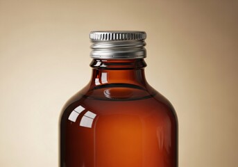 Close-up of a brown amber glass bottle with a sealed silver screw cap for medicine or cosmetics