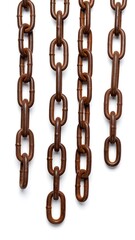 Several vertically arranged aged metal chains on a white backdrop