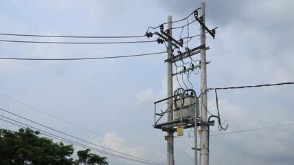 A yellow sign warns about high-voltage electricity and the dangers of hanging near high-voltage transformers.