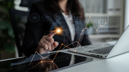 A professional businesswoman engages with innovative technology, analyzing data and financial...