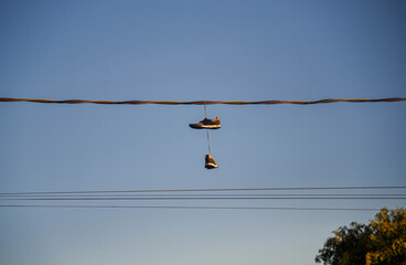 Sneakers Hanging on High-Voltage Power Line