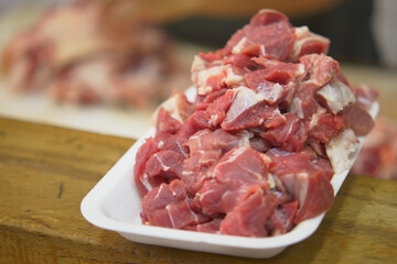 Fresh cuts of meat on display at a market stall