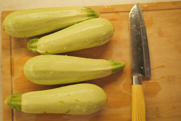 Fresh zucchini ready for cooking on a wooden cutting board