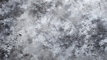 A textured gray surface with varying shades and patterns, creating an abstract appearance suitable for backgrounds or artistic designs.