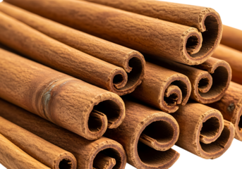 Close up view of dried cinnamon sticks piled together isolated on transparent background