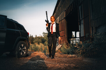 Redhead woman in a suit with a rifle. Special agent.