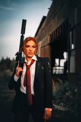 Redhead woman in a suit with a rifle. Special agent.