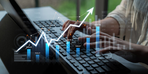 This image captures a hands-on approach to business growth, showcasing data visualization with a...
